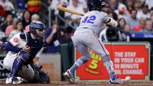 With the bases loaded, Atlanta Braves batter Ozzie Albies, right, is hit in the foot by a pitch in front of Houston Astros catcher Yainer Diaz, left, allowing the Braves' second run during the second inning of a baseball game Monday, April 15, 2024, in Houston. (AP Photo/Michael Wyke)