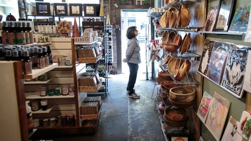 Georgia is more vulnerable to a government shutdown than most since its small businesses receive so many federal loans. Here, a shopper looks over the merchandise at Homegrown in Decatur, a locally owned store that specializes in carrying work by local artists. STEVE SCHAEFER / SPECIAL TO THE AJC