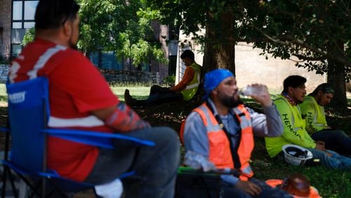 Construction workers takes a break in Atlanta’s Krog District on Thursday, June 23, 2022. Thursday’s projected high is 97 degrees, following a trend of exceptional heat that has gripped the state for more than a week. (Arvin Temkar / arvin.temkar@ajc.com)