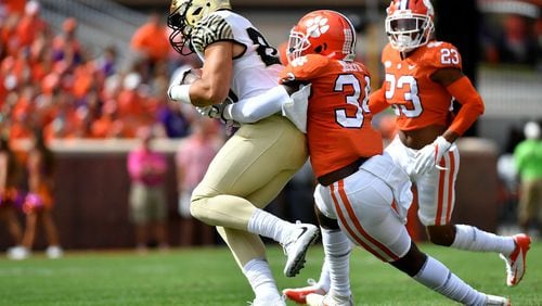 CLEMSON, SC - OCTOBER 07:  Defensive end Justin Foster #35 of the Clemson Tigers tackles tight end Cam Serigne #85 of the Wake Forest Demon Deacons during the game at Memorial Stadium on October 7, 2017 in Clemson, South Carolina. (Photo by Mike Comer/Getty Images)