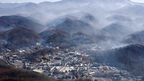 In this aerial photo, smoke rise above Gatlinburg, Tenn., Tuesday, Nov. 29, 2016, the day after a wildfire destroyed numerous homes and buildings. (Paul Efird/Knoxville News Sentinel via AP)