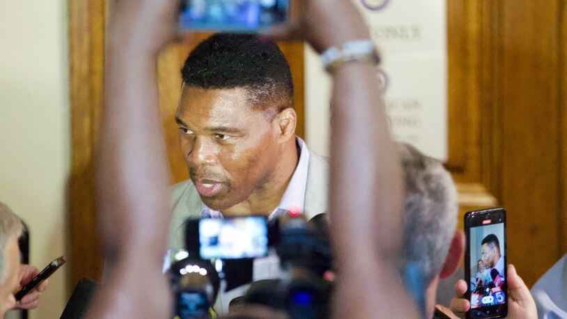 Herschel Walker speaks to journalists after filling out his paperwork to qualify to run for the U.S. Senate at the Georgia State Capitol on Monday, Mar. 7, 2022. Steve Schaefer for the Atlanta Journal-Constitution