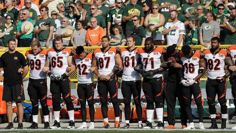 The Cincinnati Bengals lock arms during the national anthem before an NFL football game against the Green Bay Packers Sunday, Sept. 24, 2017, in Green Bay, Wis. (AP Photo/Morry Gash)