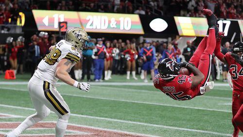 December 7, 2017 Atlanta: Falcons linebacker Deion Jones intercepts Saints quarterback Drew Brees pass intended for tight end Josh Hill (left) in the endzone to hold on to a 20-17 victory in a NFL football game on Thursday, December 7, 2017, in Atlanta.  Curtis Compton/ccompton@ajc.com
