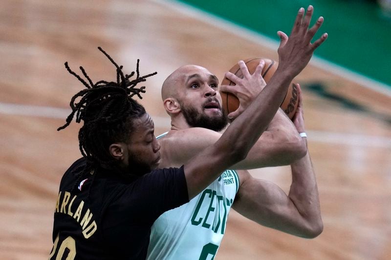 Boston Celtics guard Derrick White is pressured by Cleveland Cavaliers guard Darius Garland (10) on a drive to the basket during the first half of Game 1 of an NBA basketball second-round playoff series Tuesday, May 7, 2024, in Boston. (AP Photo/Charles Krupa)