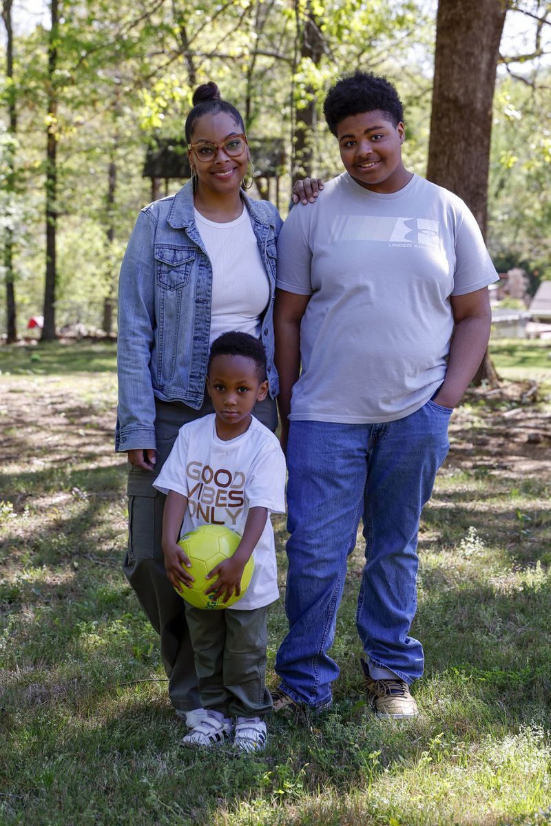 Adriane Burnett poses for a photo with her sons Karter Robinson, center, and Josiah Burnett, right, on Saturday, April 14, 2024 in Birmingham, Ala. Women's participation in the American workforce has reached a high point, but challenges around child care are holding back many working class parents. When women without college degrees face an interruption in child care arrangements – whether it's at a relative's home, a preschool or a daycare center – they are more likely to have to take unpaid time or to be forced to leave their jobs altogether, according to an Associated Press analysis. (AP Photo/Butch Dill)