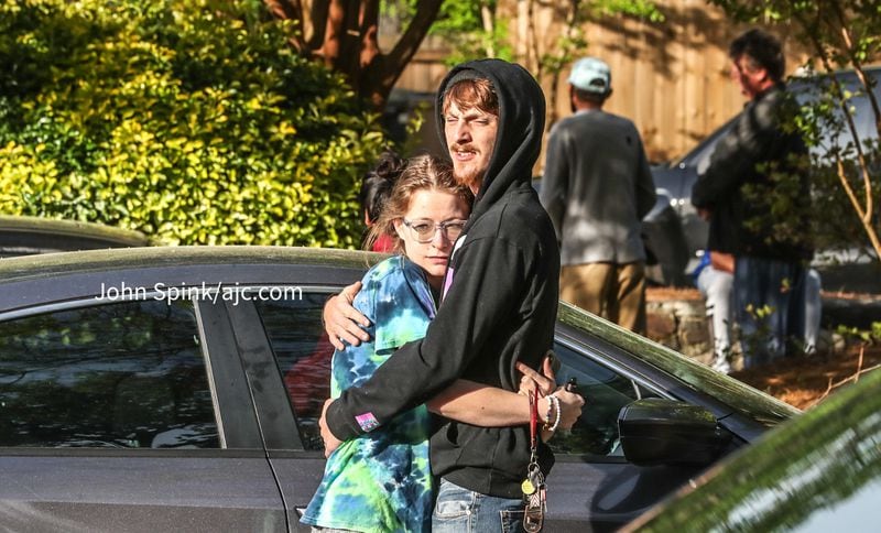 Victoria Golden is held by boyfriend Jacob Davis after their building caught on fire Friday morning.