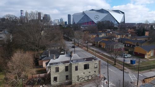 Aerial view of neighborhoods west of downtown Atlanta in the foreground and Mercedes-Benz Stadium in the background on Thursday, January 24, 2019. HYOSUB SHIN / HSHIN@AJC.COM