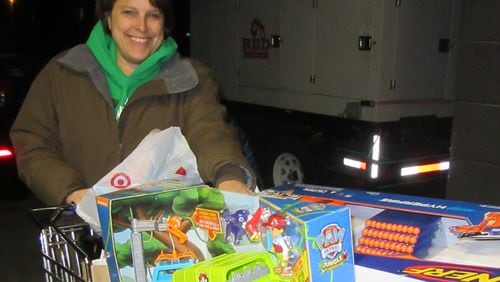 NFCC Community Events Manager Jacquie Tracy with a shopping cart full of toys for Santa Shop. NFCC’s Santa Shop provides toys and gifts to local children in need for the holidays. Donations of new, unwrapped toys and gift cards are arranged in a toy store format and qualified parents have the opportunity to pick out their child’s holiday gifts. Donations are accepted at the holiday distribution site in Alpharetta.