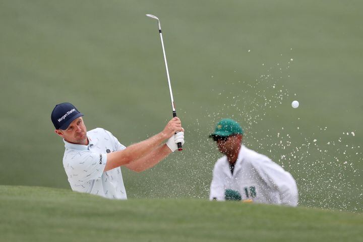 April 8, 2021, Augusta: Justin Rose hits out of the bunker on the fifteenth hole during the first round of the Masters at Augusta National Golf Club on Thursday, April 8, 2021, in Augusta. Curtis Compton/ccompton@ajc.com