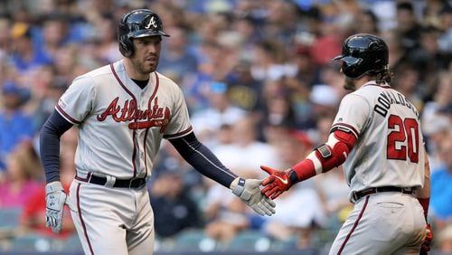 Freddie Freeman #5 and Josh Donaldson #20 of the Atlanta Braves celebrate after Freeman hit a home run in the fourth inning against the Milwaukee Brewers at Miller Park on July 15, 2019 in Milwaukee, Wisconsin. (Photo by Dylan Buell/Getty Images)