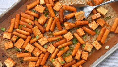 The tofu in Spicy Sheet Pan Tofu is accompanied by tteok, a dumpling-like rice cake. 
(Chris Hunt for The Atlanta Journal-Constitution)