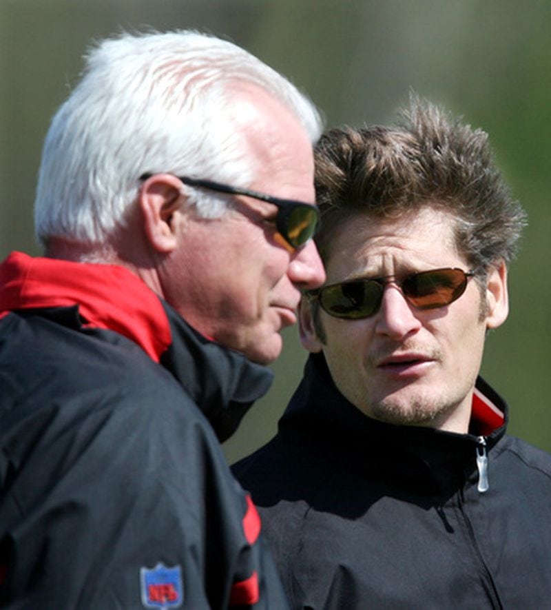 General manager Thomas Dimitroff, right, confers with head coach Mike Smith as they take in the second day of the Atlanta Falcons veteran mini-camp at the team's Flowery Branch headquarters Tuesday.