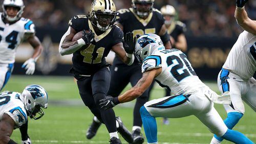Saints running back Alvin Kamara runs the ball against the Panthers during the second half of an NFL game at the Mercedes-Benz Superdome on December 3 in New Orleans, Louisiana.