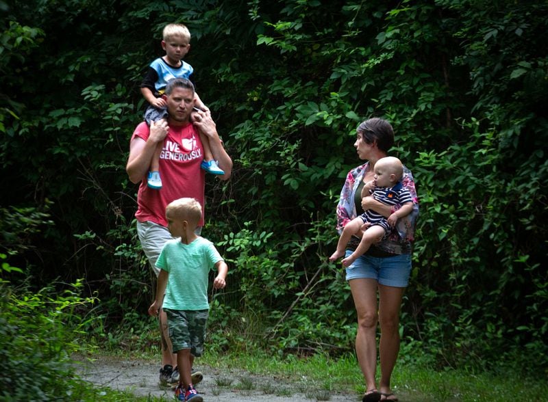 Angie Rush and her husband Aaron, along with their three sons, Carter, 1, Tristen, 6, and Caison, 3, take a walk near her Marietta home on July 27, 2020.  STEVE SCHAEFER FOR THE ATLANTA JOURNAL-CONSTITUTION