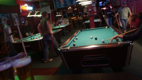 Patrons play pool at Famous Pub. / AJC file photo