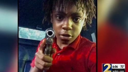 A Facebook photo of 14-year-old Reginald Lofton holding a gun was presented in Gwinnett County court Friday during a hearing in the murder of a pizza delivery driver. (Credit Channel 2 Action News)