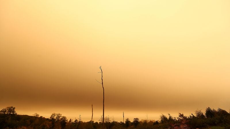 The sky turns orange and yellow in Brittany Monday, Oct.16, 2017 in Chasne-sur-Illet, western France. The sky in France's Brittany region turned yellow as nearby Ophelia storm brought a mix of sand from Sahara and particles from Spain and Portugal's forest fires over the region. Ophelia post-tropical cyclone passed west of the Brittany coast Monday before bringing violent winds to Ireland and the United Kingdom. (AP Photo/David Vincent)