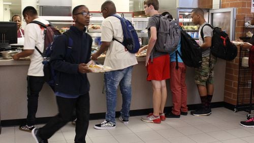 Students get lunch at Paul Duke STEM High School in Gwinnett County during a lunch period in 2018. During the pandemic, Gwinnett provided meals for free. Next school year, the district will reinstate charging for meals. (Jenna Eason / AJC file photo)
