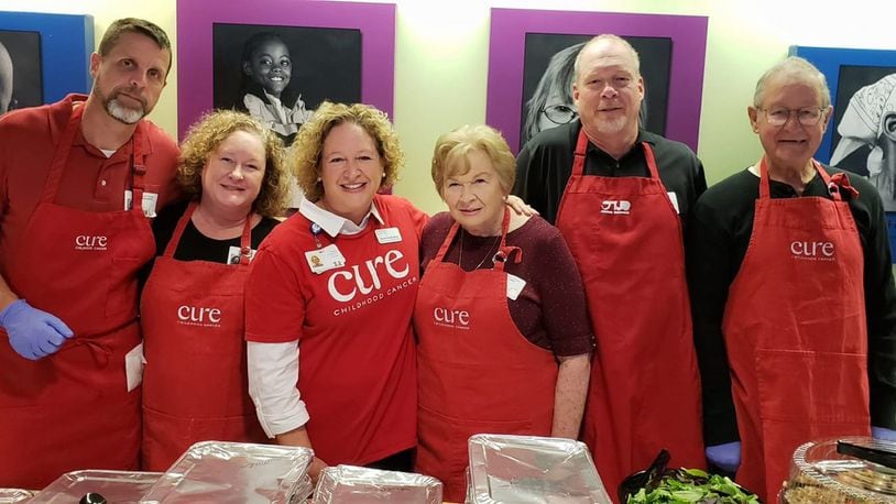 Karen Rutherford (third from left) and members of her family gather for a photo last year at Children’s Healthcare of Atlanta at Egleston. The Rutherfords volunteer annually to help serve Thanksgiving dinner to children with cancer and their families who are unable to be at home. CONTRIBUTED