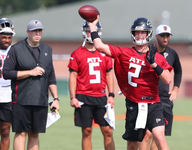 Falcons head coach Arthur Smith (left) and offensive coordinator Dave Ragone (far right) look on as Matt Ryan looks to pass against the defense on the third day of training camp practice Saturday, July 31, 2021, in Flowery Branch. (Curtis Compton / Curtis.Compton@ajc.com)