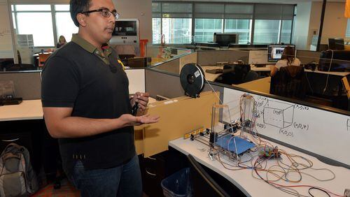 JANUARY 20, 2014 ATLANTA Tech student Ash Bahtnagar, 5th year computer science and nuclear engineering student displays a prototype 3D printer during a tour. KENT D. JOHNSON/KDJOHNSON@AJC.COM