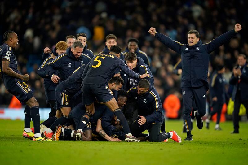 Real Madrid players celebrate after wining the Champions League quarterfinal second leg soccer match between Manchester City and Real Madrid at the Etihad Stadium in Manchester, England, Wednesday, April 17, 2024. (AP Photo/Dave Thompson)