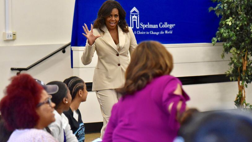 Former first lady Michelle Obama waves at students as she enters a discussion at Spelman College on Saturday, May 11, 2019, about her memoir, “Becoming.” HYOSUB SHIN / HSHIN@AJC.COM