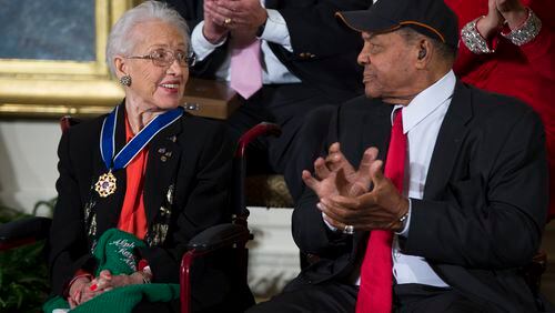 Katherine Johnson is a physicist, space scientist, and mathematician who contributed to America's aeronautics and space programs with the early application of digital electronic computers at NASA. Known for accuracy in computerized celestial navigation, she calculated the trajectory for Project Mercury and the 1969 Apollo 11 flight to the Moon. In 2015, President Barack Obama presented her with the Presidential Medal of Freedom. (AP Photo/Evan Vucci)