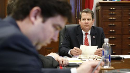 Brian Kemp in a staff meeting at his office in the Capitol. BOB ANDRES / BANDRES@AJC.COM