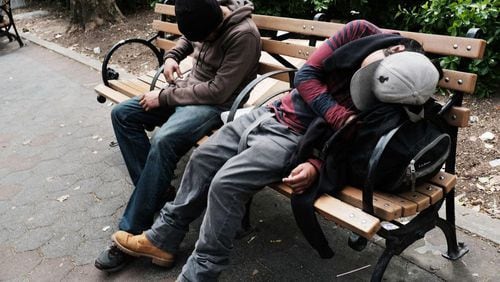 Men sit passed out on a park bench in New York City. Seattle is trying to expand it’s safe injection sites program to reduce the chances of people dying, but a new study contends the sites won’t help.
