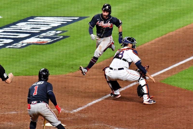 Braves shortstop Dansby Swanson scores a run ahead of the tag by Houston Astros catcher Jason Castro (18) during the eighth inning in game 1 of the World Series at Minute Maid Park, Tuesday October 26, 2021, in Houston, Tx. Hyosub Shin / Hyosub.Shin@ajc.com