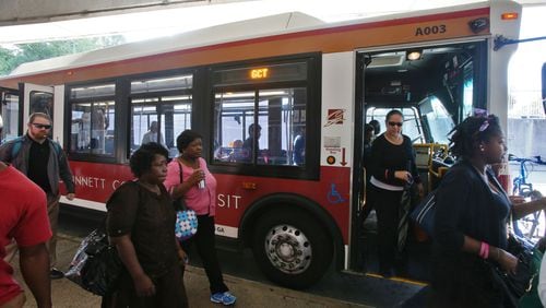 Sep. 23, 2013 - Gwinnett, Fulton, Cobb County - Riders disembark from the Gwinnett County 10a bus at the Doraville MARTA station. Reporter Andria Simmons rode a Gwinnett County Transit bus from the transit center in Duluth to the Doraville MARTA station, transfered to a MARTA train southbound to Arts Center Station in Atlanta then boarded Cobb County Transit Bus # 10 to the Marietta Park & Ride lot on South Marietta Parkway in Marietta. The entire journey took 2 1/2 hours.