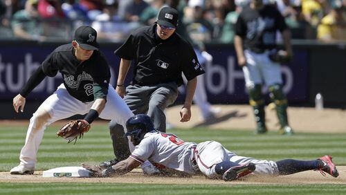 Danny Santana slides at third base for one of his three stolen bases in the late innings of a July 1 win at Oakland. (AP Photo/Ben Margot)