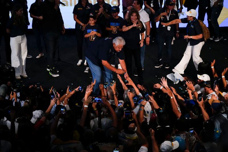 Presidential candidate Jose Raul Mulino, of the Achieving Goals party, hold hands with a supporter after winning on the day of the general electing in Panama City, Sunday, May 5, 2024. (AP Photo/Matias Delacroix)
