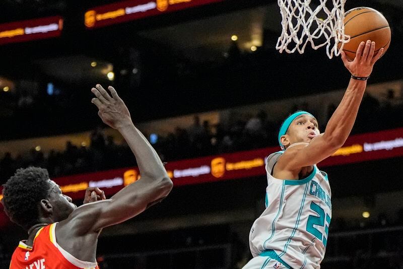Charlotte Hornets guard Tre Mann (23) goes to the basket against Atlanta Hawks forward Mouhamed Gueye (18) during the first half of an NBA basketball game, Wednesday, April 10, 2024, in Atlanta. (AP Photo/Mike Stewart)