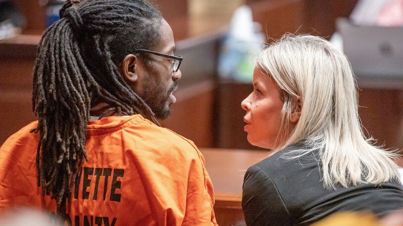 Black Hammer leader Augustus Claudius Romain Jr., 36, known as Gazi Kodzo, talks with his attorney Stacey Flynn after his hearing at the County Justice Center in Fayetteville Wednesday, August 17, 2022. Steve Schaefer/steve.schaefer@ajc.com)