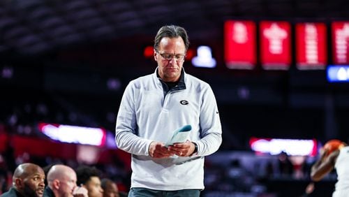 Georgia head coach Tom Crean looks at his notes during a recent game. (Photo by Tony Walsh/UGA Athletics)
