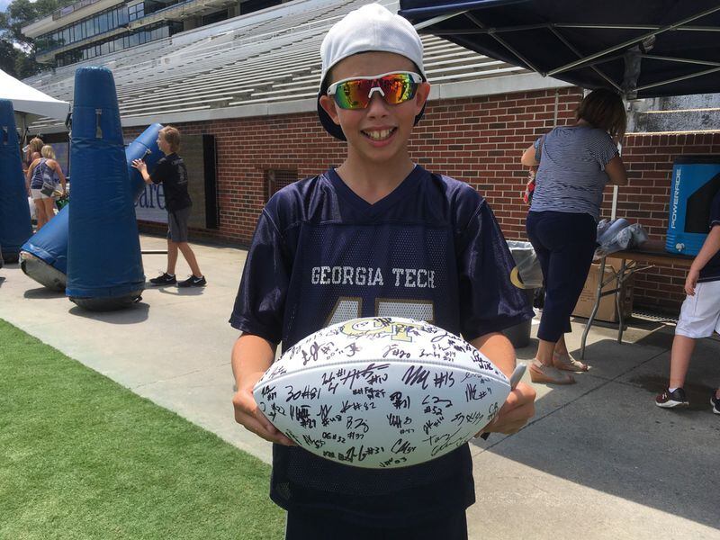 Georgia Tech fan Wesley Dawson, 10, of Lawrenceville, shows off autographs received at Tech's fan day at Bobby Dodd Stadium August 3, 2019. (AJC photo by Ken Sugiura)