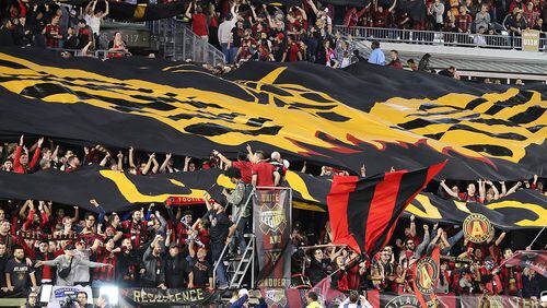 Fans unfurl the Atlanta United FC tifo to open the action against the New York Red Bulls during their first game in franchise history Sunday, March 5, 2017, in Atlanta. Curtis Compton/ccompton@ajc.com