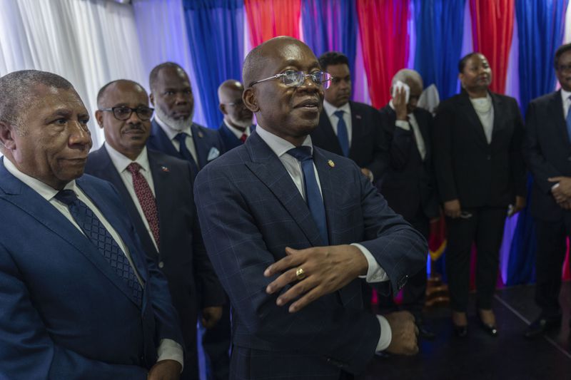 Michel Patrick Boisvert, center, who was named interim Prime Minister by outgoing Prime Minister Ariel Henry, attends the swearing-in ceremony of the transitional council tasked with selecting Haiti's new prime minister and cabinet, in Port-au-Prince, Haiti, Thursday, April 25, 2024. Boisvert was previously the economy and finance minister. (AP Photo/Ramon Espinosa)