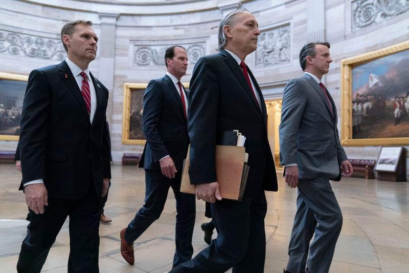 House Impeachment Managers from left, Rep. Michael Guest, R-Miss., Rep. August Pfluger, R-Texas, Rep. Andy Biggs, R-Ariz., and Rep. Ben Cline, R-Va., walk cross the Capitol Rotunda to the Senate chamber to deliver Homeland Security Secretary Alejandro Mayorkas Impeachment Articles at the Capitol in Washington, Tuesday, April 16, 2024. (AP Photo/Jose Luis Magana)