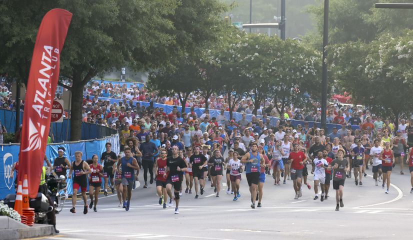 Runners take off at the start of the 53rd running of the Atlanta Journal-Constitution Peachtree Road Race in Atlanta on Monday, July 4, 2022. (Jason Getz / Jason.Getz@ajc.com)