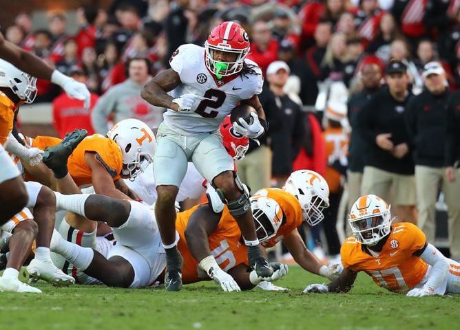 Georgia running back Kendall Milton works his way through Tennessee defenders for yardage during the second quarter in a NCAA college football game on Saturday, Nov. 18, 2023, in Knoxville.  Curtis Compton for the Atlanta Journal Constitution