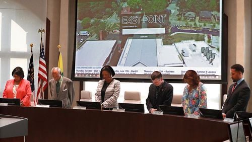 East Point City Council memmbers bow in prayer to open a meeting on Monday, June 3, 2019, in East Point. (Curtis Compton/ccompton@ajc.com)