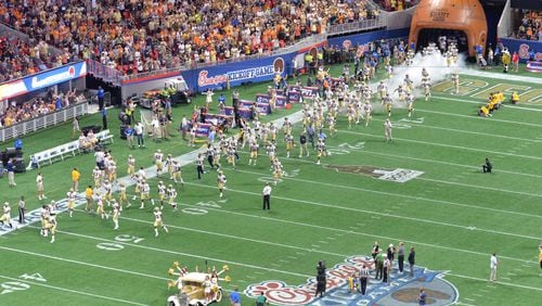 September 4, 2017 Atlanta - GA Tech's Ramblin Wreck and cheerleaders lead the football on the field before NCAA college football game against the Tennessee at the Mercedes-Benz Stadium on Monday, September 4, 2017. (HYOSUB SHIN / HSHIN@AJC.COM)