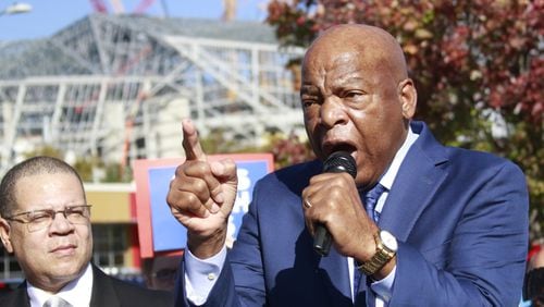 Congressman John Lewis makes a few remarks before leading a march to vote, along with Fulton County Chairman John Eaves (left). BOB ANDRES /BANDRES@AJC.COM AJC File Photo