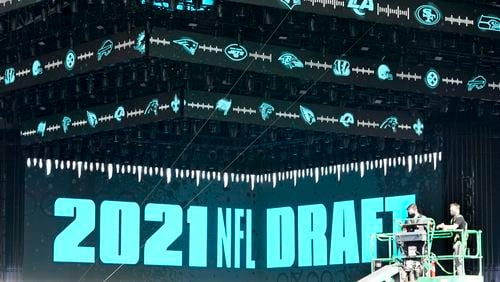 Workers continue preparing the NFL Draft Theatre for the 2021 NFL draft, Tuesday, April 27, 2021, in Cleveland. After going all virtual in 2020 due to the COVID-19 pandemic, the three-day draft, which has grown into one of America's biggest, non-game sporting events, returns with thousands of fans who will be separated by their loyalties, and whether they've been vaccinated. (AP Photo/Tony Dejak)