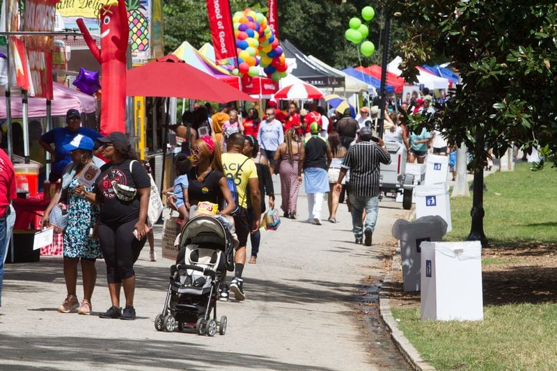 People walk by and visit the vendor booths during the Pure Heat Community Festival celebrating Atlanta Black Pride Weekend in Piedmont Park on Sunday, September 2, 2018. (Photo: STEVE SCHAEFER / SPECIAL TO THE AJC)