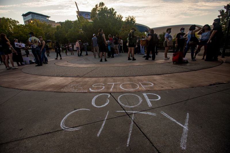 Protestors marched to the World of Coca-Cola to demonstrate against the proposed police training facility. (Jenni Girtman for The Atlanta Journal-Constitution)